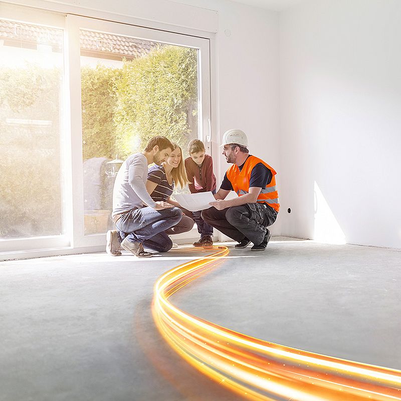 vier personen in hocke betrachten einen plan